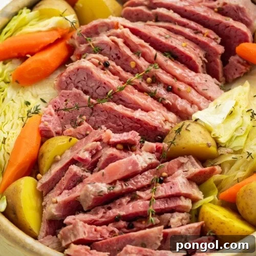 Overhead angled view of a large bowl of corned beef, cabbage, potatoes, and carrots