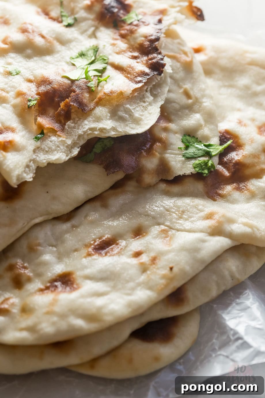 Serving homemade naan with a curry dish.