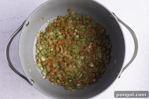 Onions, celery, and carrots in large heavy-bottomed pot with bacon drippings.