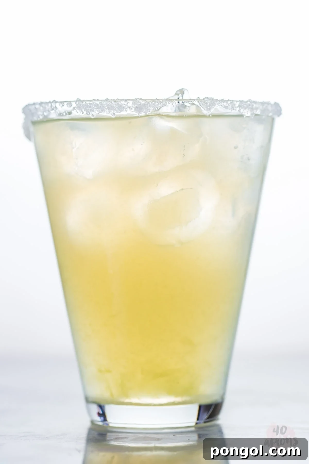 A vibrant, frosty healthy margarita served in a salt-rimmed glass, garnished with a lime wedge.
