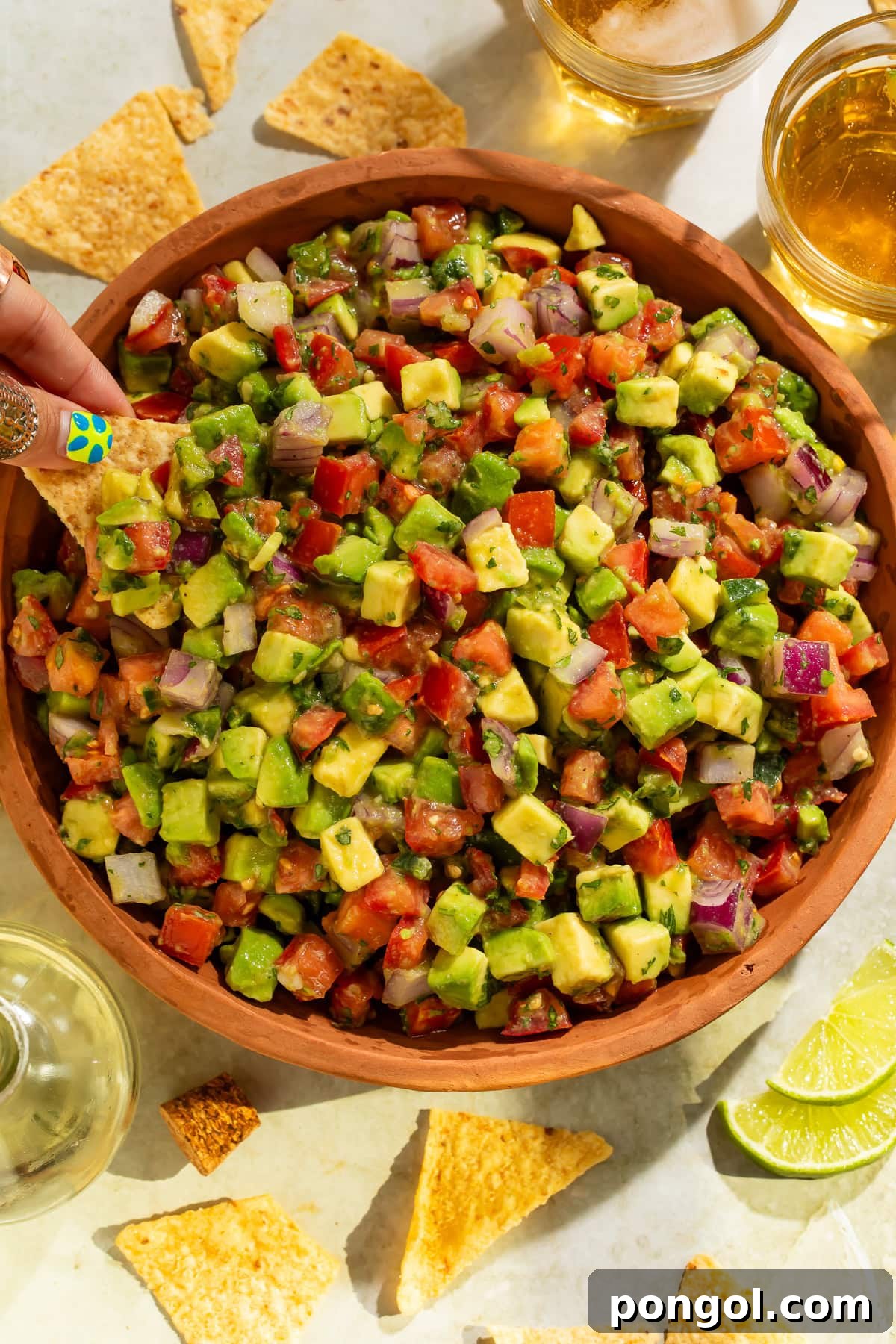 Close-up overhead view of fresh avocado tomato salsa showing colorful diced vegetables