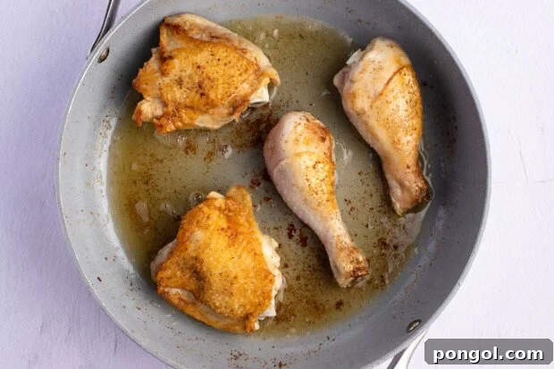 Chicken thighs and drumsticks in large skillet.