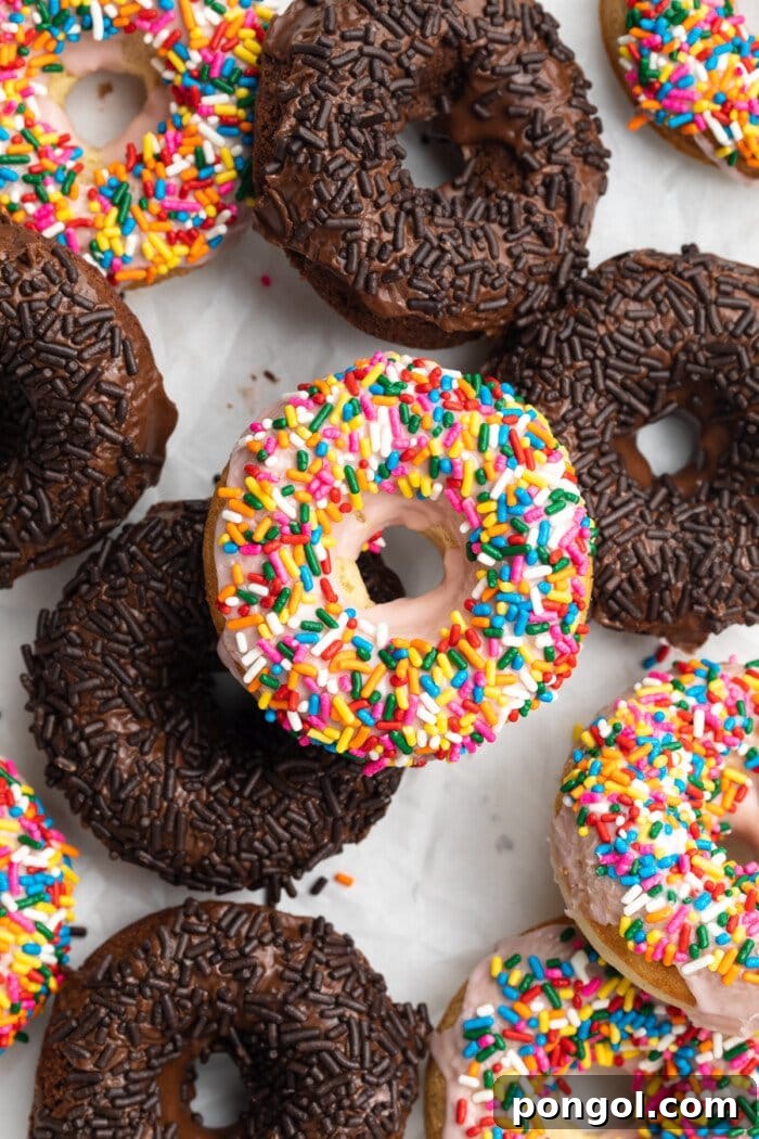 Overhead view of chocolate and vanilla gluten-free donuts with colorful sprinkles, showcasing their soft, inviting texture.