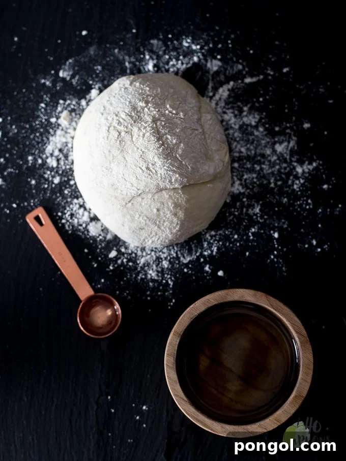 Preparing Perfect Food Processor Pizza Dough. The ingredients are combined quickly and easily in the food processor, leading to a perfect dough ball ready for rising. Homemade pizza has never been simpler.