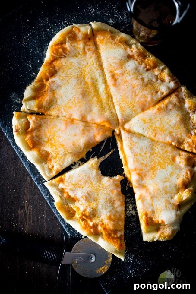 Perfectly grilled pizza with a crispy crust and melted cheese, ready to be sliced.