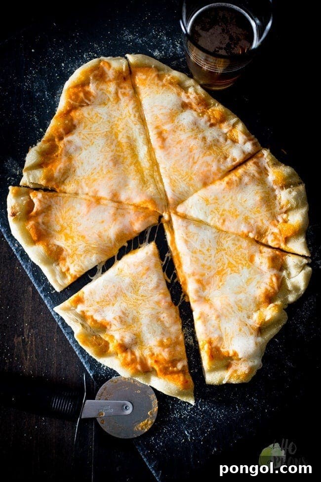 Grilled pizza crust with sauce and melted mozzarella cheese, topped with fresh basil.