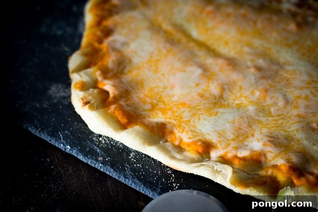 A delicious slice of homemade grilled pizza, showing crispy crust and melted toppings.