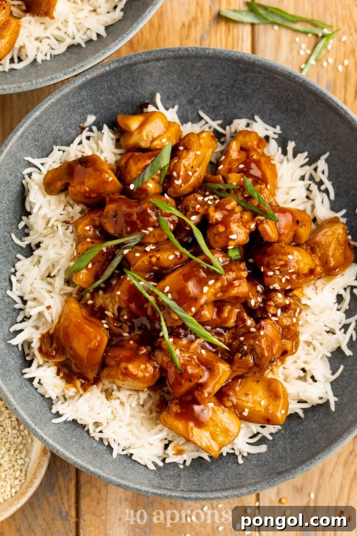 Sticky Bourbon Glazed Chicken 3 Close-up, overhead view of a bowl of Bourbon chicken on a bed of white rice.