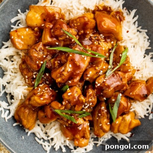 Sticky Bourbon Glazed Chicken 4 Close-up, overhead view of a bowl of Bourbon chicken on a bed of white rice.