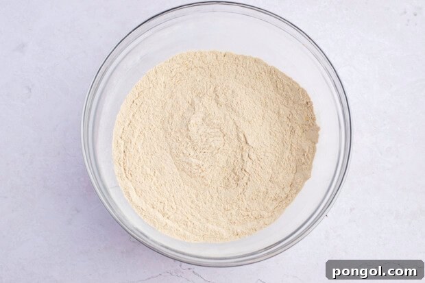 Crispy Seitan Chicken Tenders 6 Overhead view of dry ingredients for seitan fried "chicken" tenders in a large glass mixing bowl.