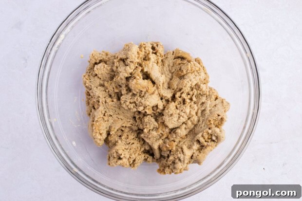 Crispy Seitan Chicken Tenders 7 Overhead view of seitan fried "chicken" dough in large glass mixing bowl on white surface.
