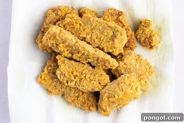 Crispy Seitan Chicken Tenders 9 Overhead view of seitan fried "chicken" tenders on a paper towel lined plate.