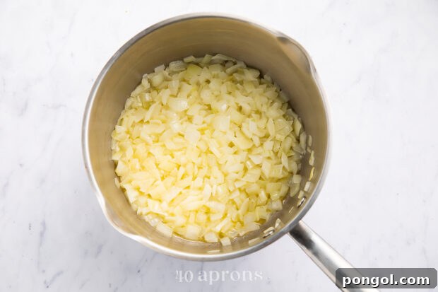 Sautéed garlic and onions in a saucepan.