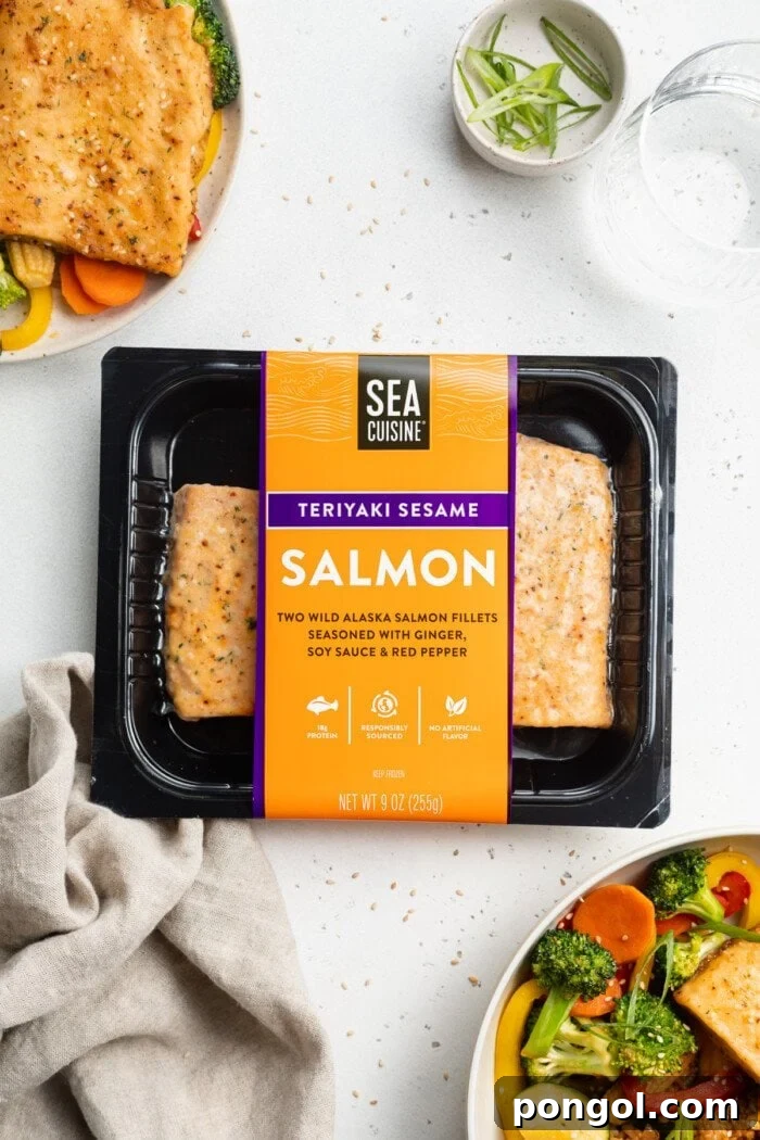 Overhead view of a package of Sea Cuisine's Teriyaki Sesame Wild Alaska Salmon fillets on a kitchen counter, surrounded by fresh ingredients for hibachi fried rice and vegetables.