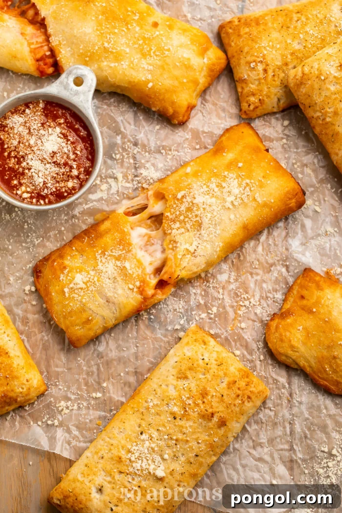 Air Fryer Hot Pockets From Freezer to Fresh 2 Overhead view of air fryer hot pockets (frozen and homemade) on parchment paper with pizza sauce, showcasing their golden, crispy crusts.