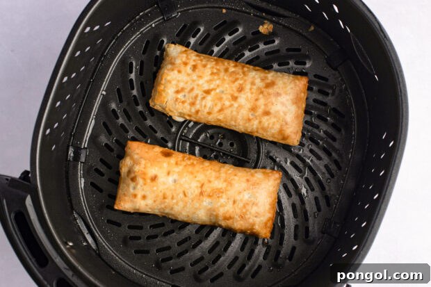 Air Fryer Hot Pockets From Freezer to Fresh 7 Overhead view of cooked frozen hot pockets in air fryer basket, showing their golden crust.