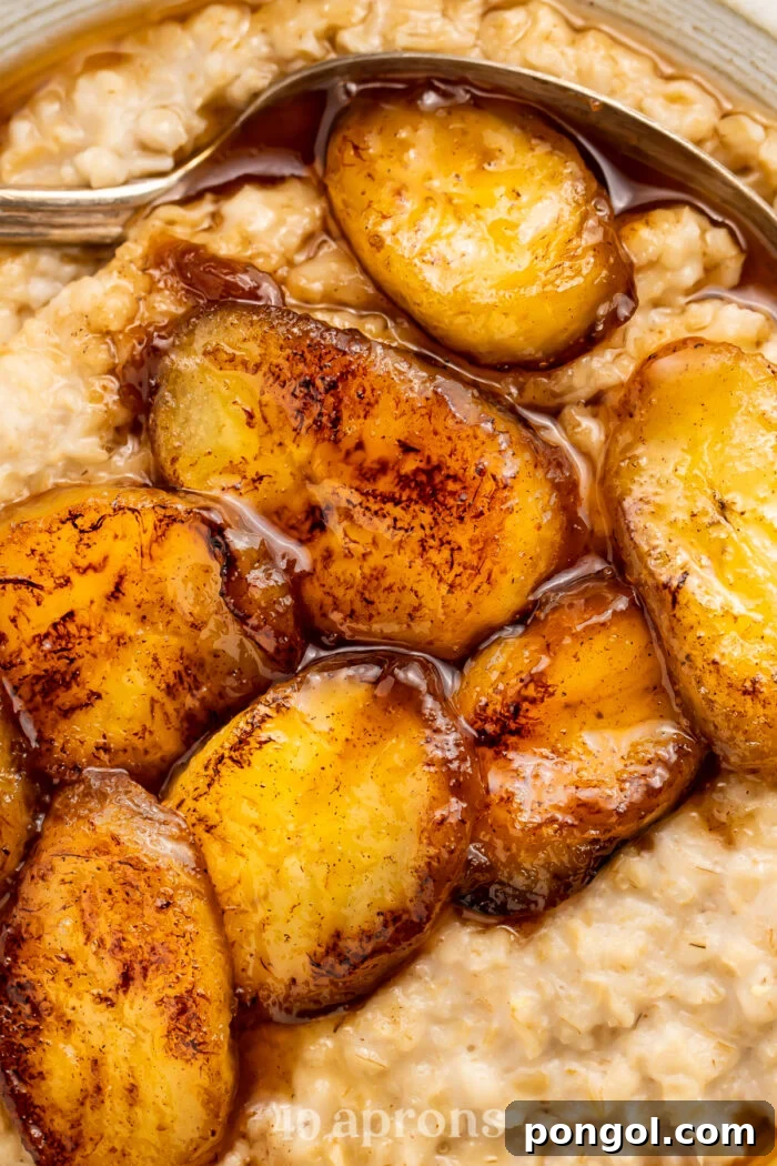 Close-up of maple syrup caramelized bananas on top of a bed of oatmeal.