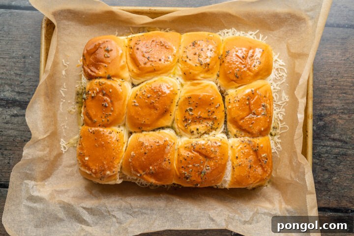 Melted butter seasoned with Italian seasoning and garlic powder, ready to be brushed on sliders.