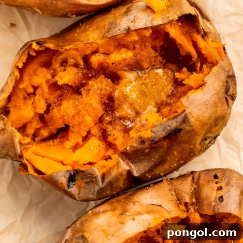 Overhead view of a row of cut-open sweet potatoes angling from the top left corner of the image to the bottom right corner.