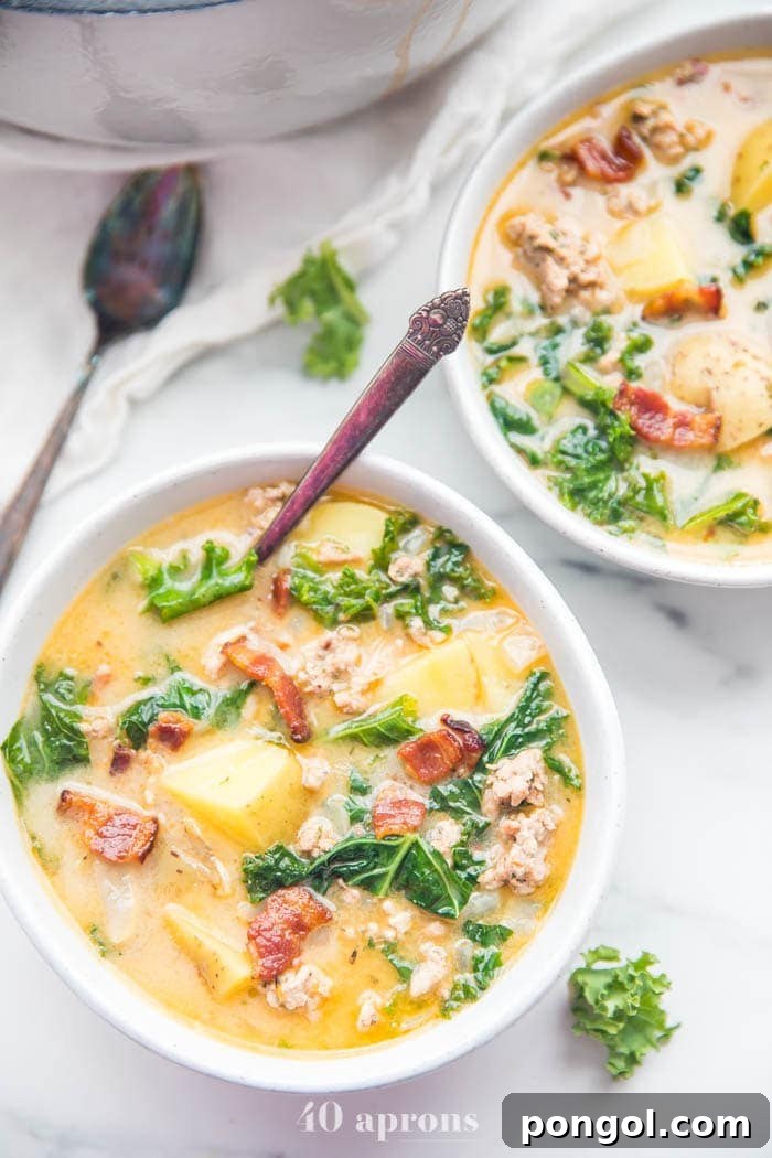 Two bowls of Whole30 healthy Zuppa Toscana recipe, garnished with fresh parsley