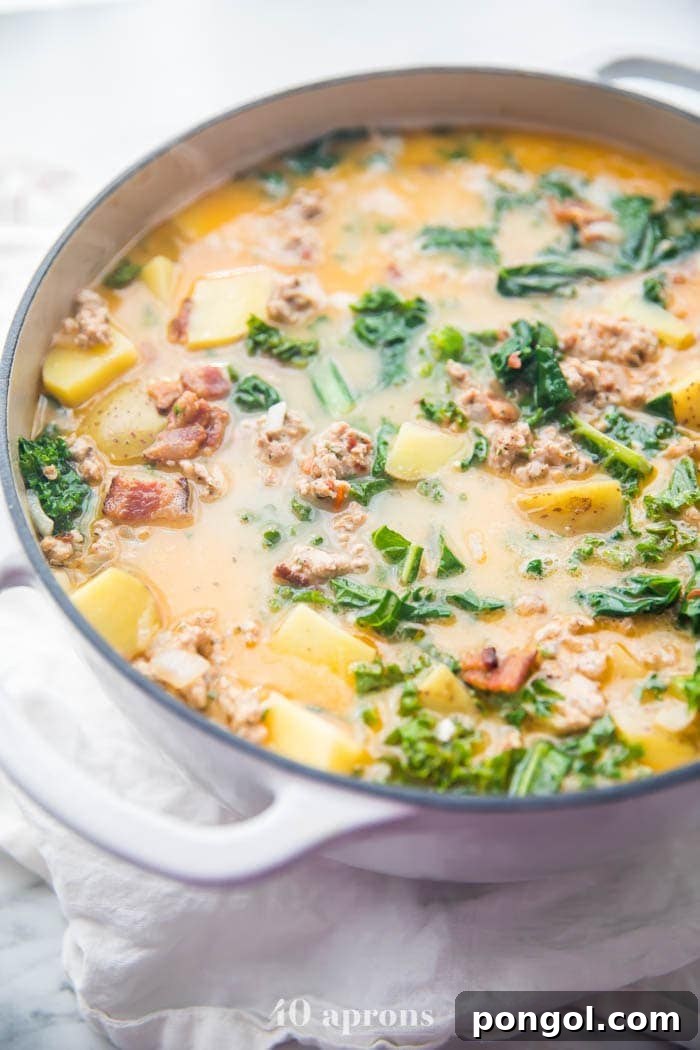 A large pot of Whole30 healthy zuppa toscana simmering on the stove