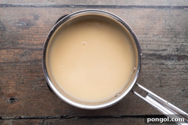 Effortless Holiday Feast 11 Creamy flour-based gravy in a saucepan