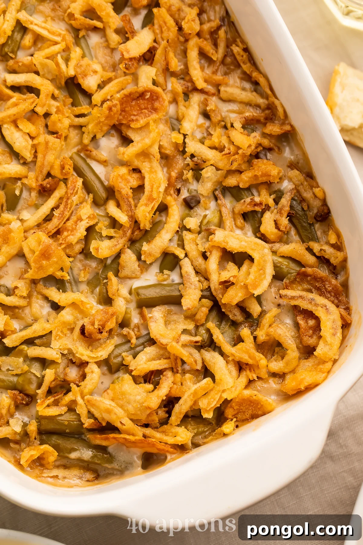 Make Ahead Green Bean Bake 3 Close up, overhead view of an angled casserole dish holding a make ahead green bean casserole.