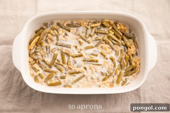 Make Ahead Green Bean Bake 6 Overhead view of an unbaked make ahead green bean casserole in a large casserole dish.