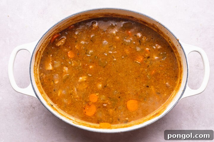 Overhead view of pork stew in a large dutch oven.