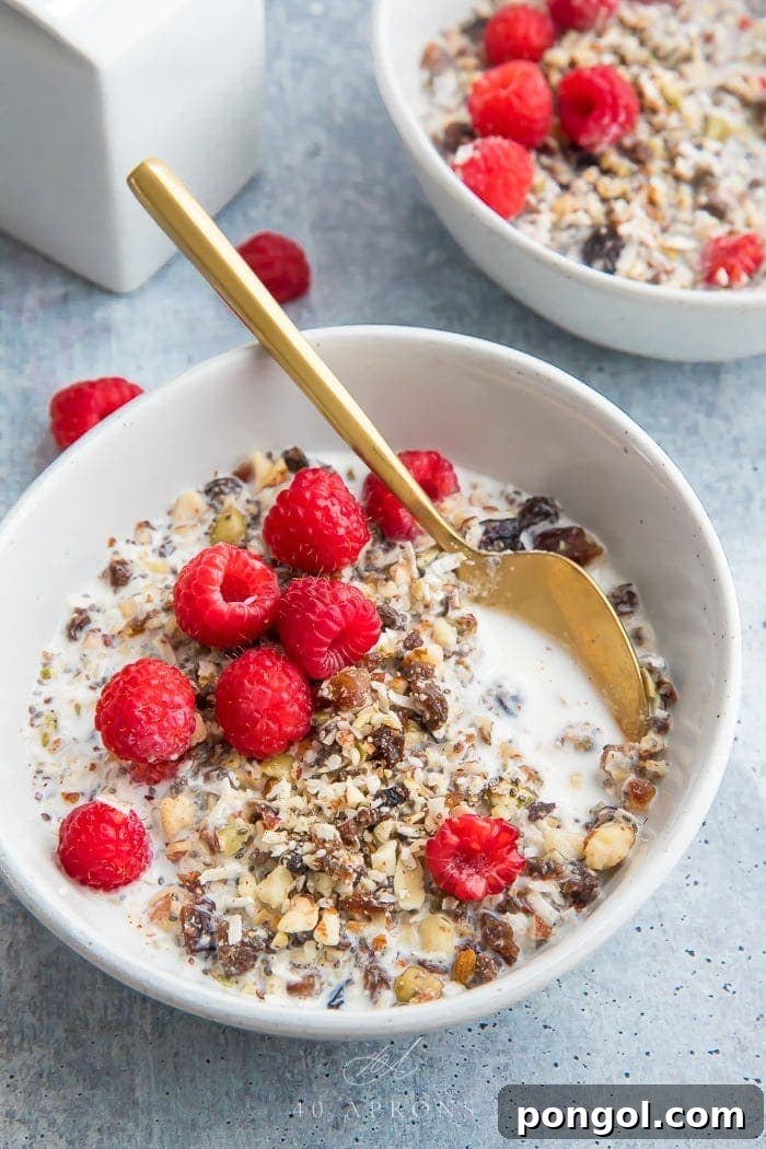 Two bowls of paleo cereal topped with raspberries