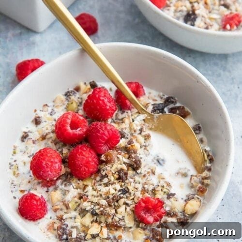 Two bowls of paleo cereal topped with raspberries