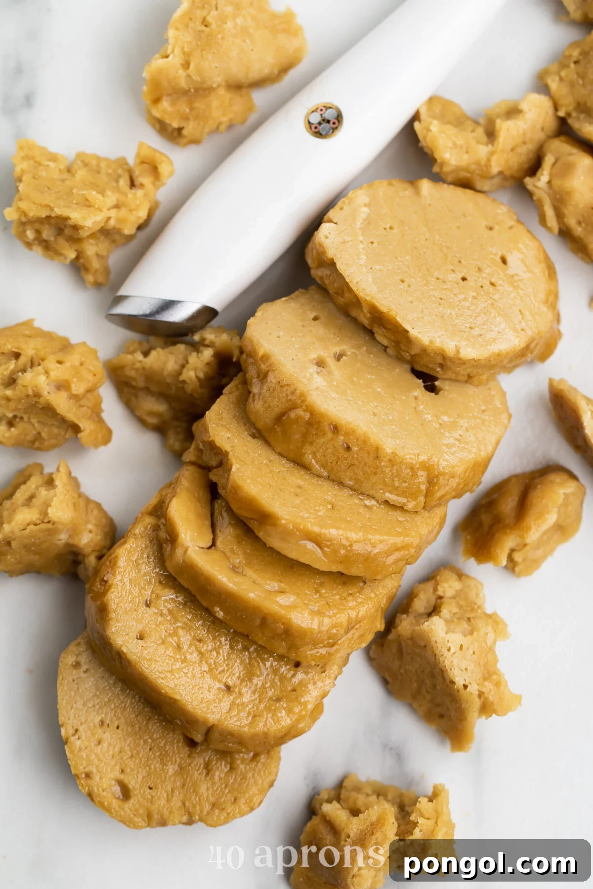 An overhead shot of a freshly steamed seitan loaf, expertly sliced into uniform rounds, ready for further culinary preparation.
