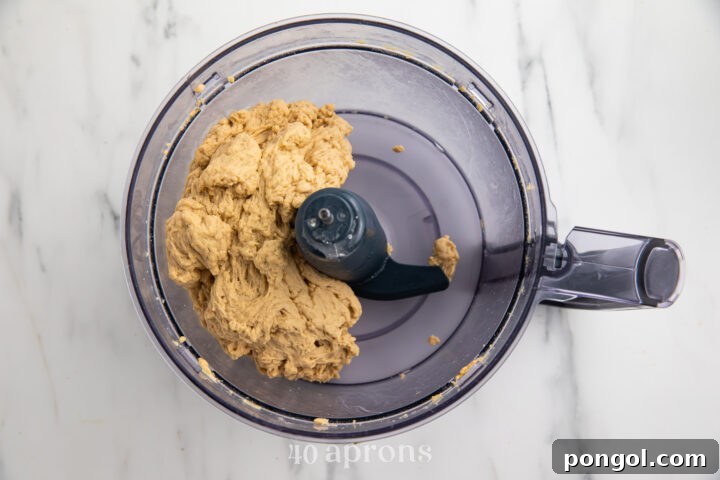 Ingredients for seitan in a food processor bowl, ready to be mixed into dough.