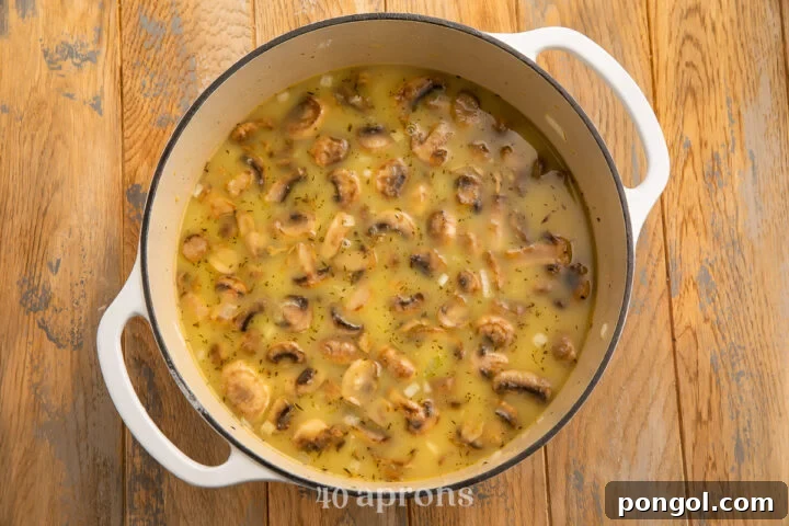 Overhead view of chicken and wild rice soup in a large heavy soup pot.