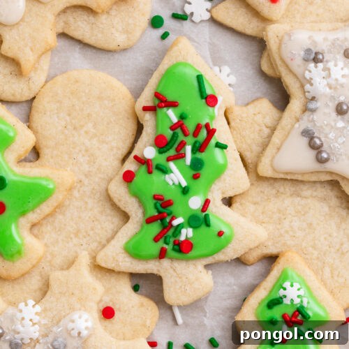 Overhead view of decorated gluten-free Christmas cookies, with a green tree-shaped cookie front and center.