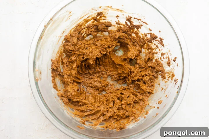 Overhead view of butter and brown sugar creamed together in a large mixing bowl.
