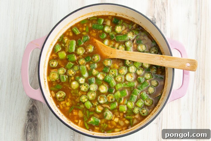 Cajun 15-bean vegetarian gumbo with 2 cups of okra and plenty of spices in a large heavy-bottomed pot with two handles.