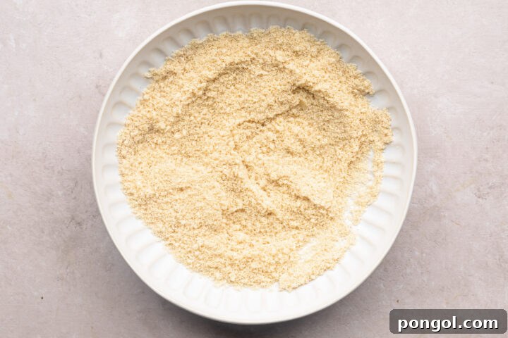 Breading mixture for keto chicken nuggets, made up of almond flour and spices.