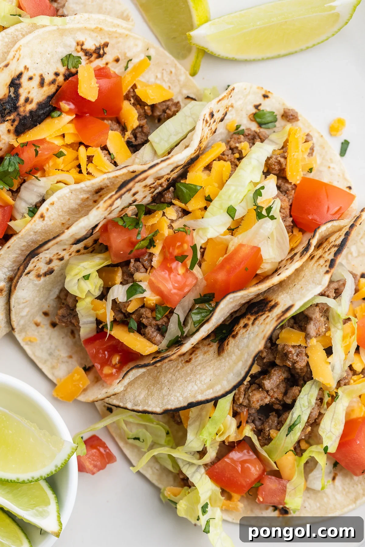 Keto Tacos From Scratch: Homemade Low-Carb Tortillas 2 Close-up view of 3 keto tacos in homemade keto tortillas with lettuce and salsa, ready to be enjoyed.