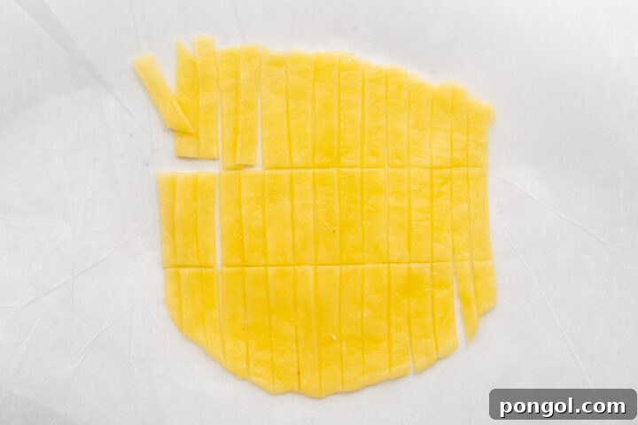 Strips of keto noodles on parchment paper.