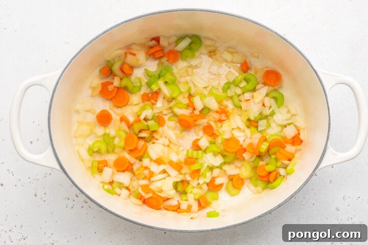 Softened onions, celery, and carrots in a large oval soup pot.