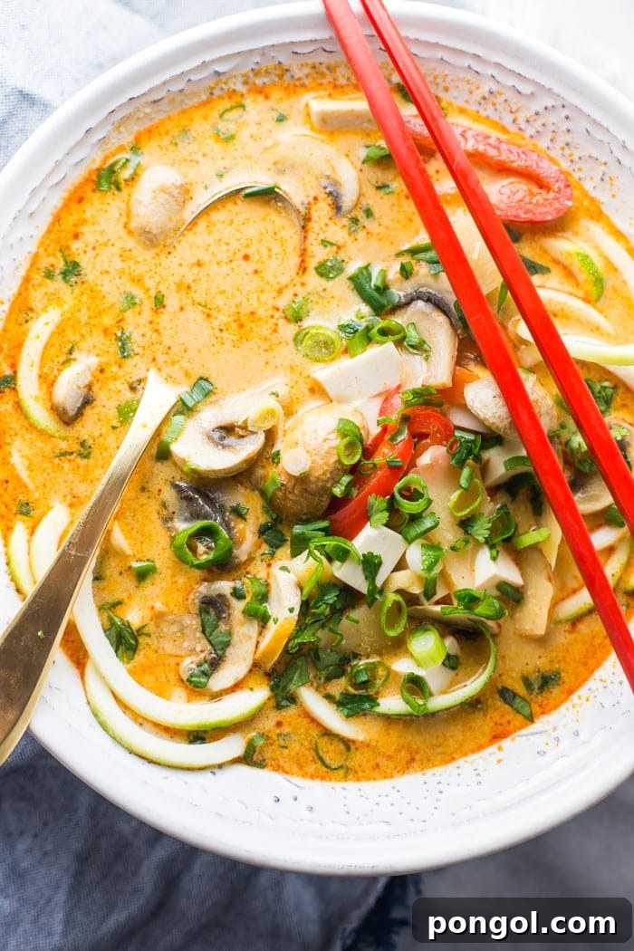 Close-up of Paleo Coconut Curry Zoodle Soup, showcasing the vibrant colors and fresh ingredients. A delicious gluten-free and dairy-free meal option.
