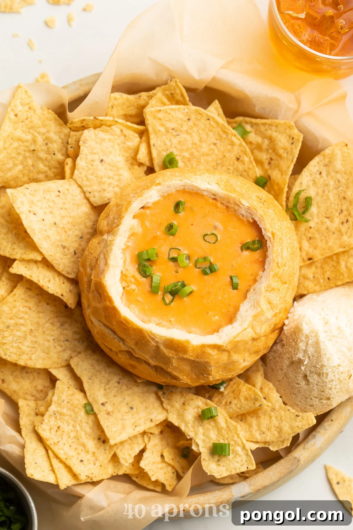 Homemade McAlister's Chicken Tortilla Soup Recipe 2 Top-down view of McAlister’s Chicken Tortilla Soup copycat in a bread bowl surrounded by tortilla chips, with a vibrant and inviting appeal.
