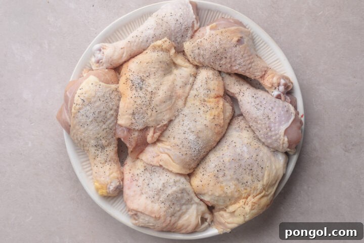 Sweet and Spicy Gochujang Sheet Pan Feast 6 Seasoned, uncooked chicken thighs arranged on a round white plate.