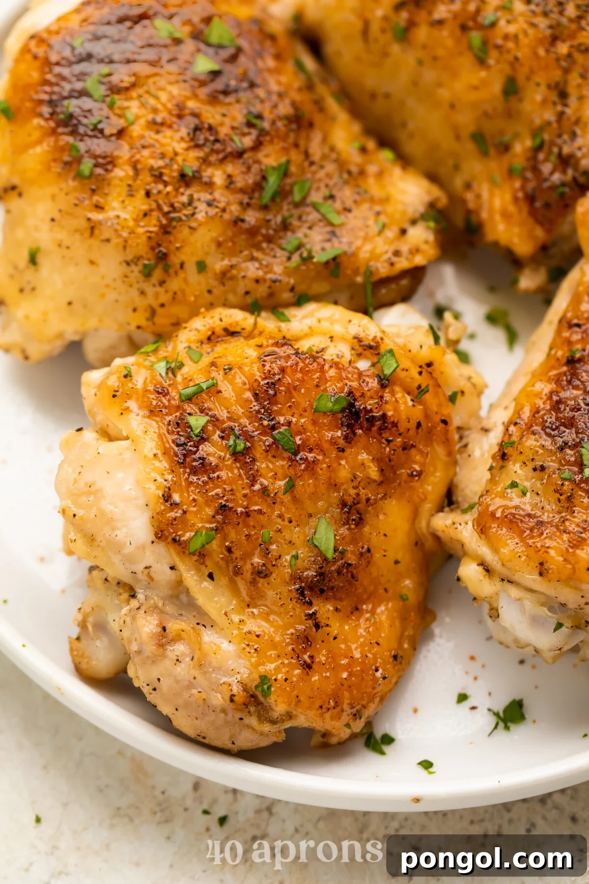 Overhead look at crispy, perfect Instant Pot chicken thighs on a plate.