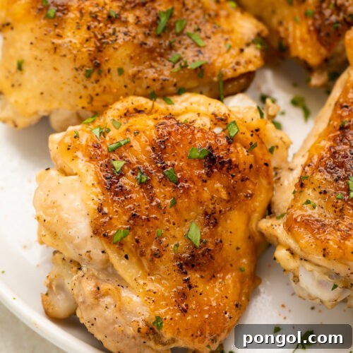 Overhead look at crispy, perfect Instant Pot chicken thighs on a plate.